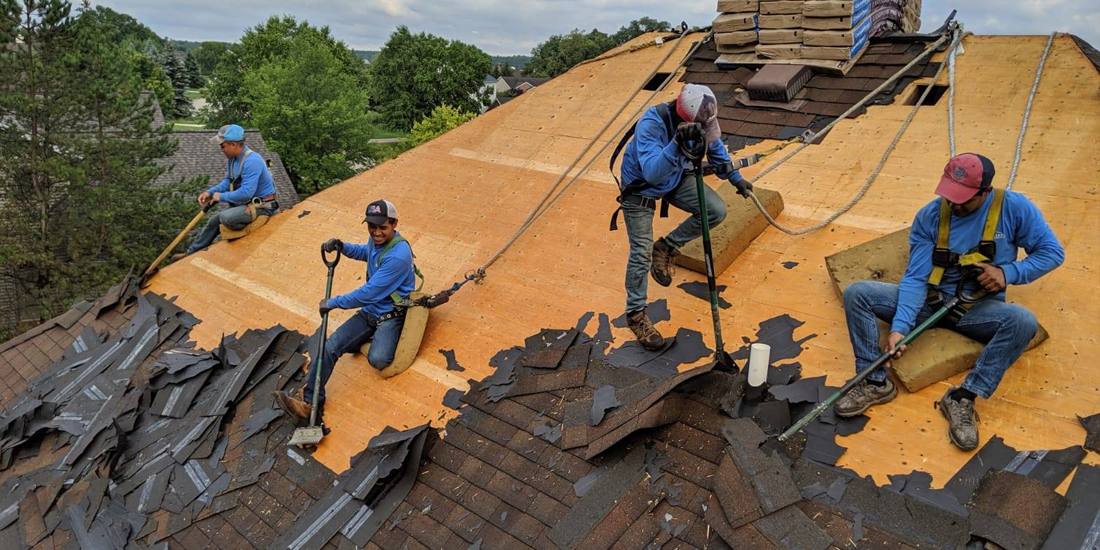Contractors replacing residential asphalt roof in Grand Rapids